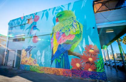 Portrait of a bird painted on the wall of a shop.