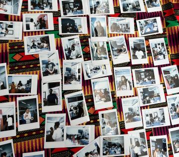 Polaroid photos of an event placed on a table for all to see.