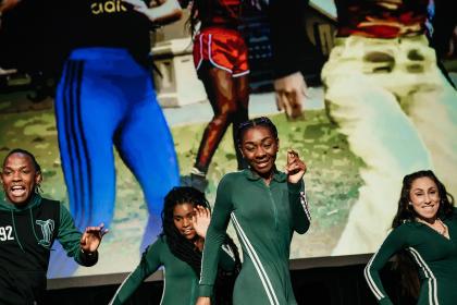 Image of people dancing/performing on stage.