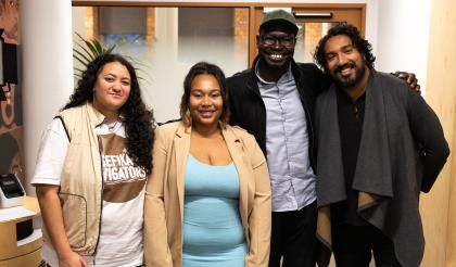 Four people standing together facing the camera and smiling. All of the people have been involved in the Mental Health Literacy Project